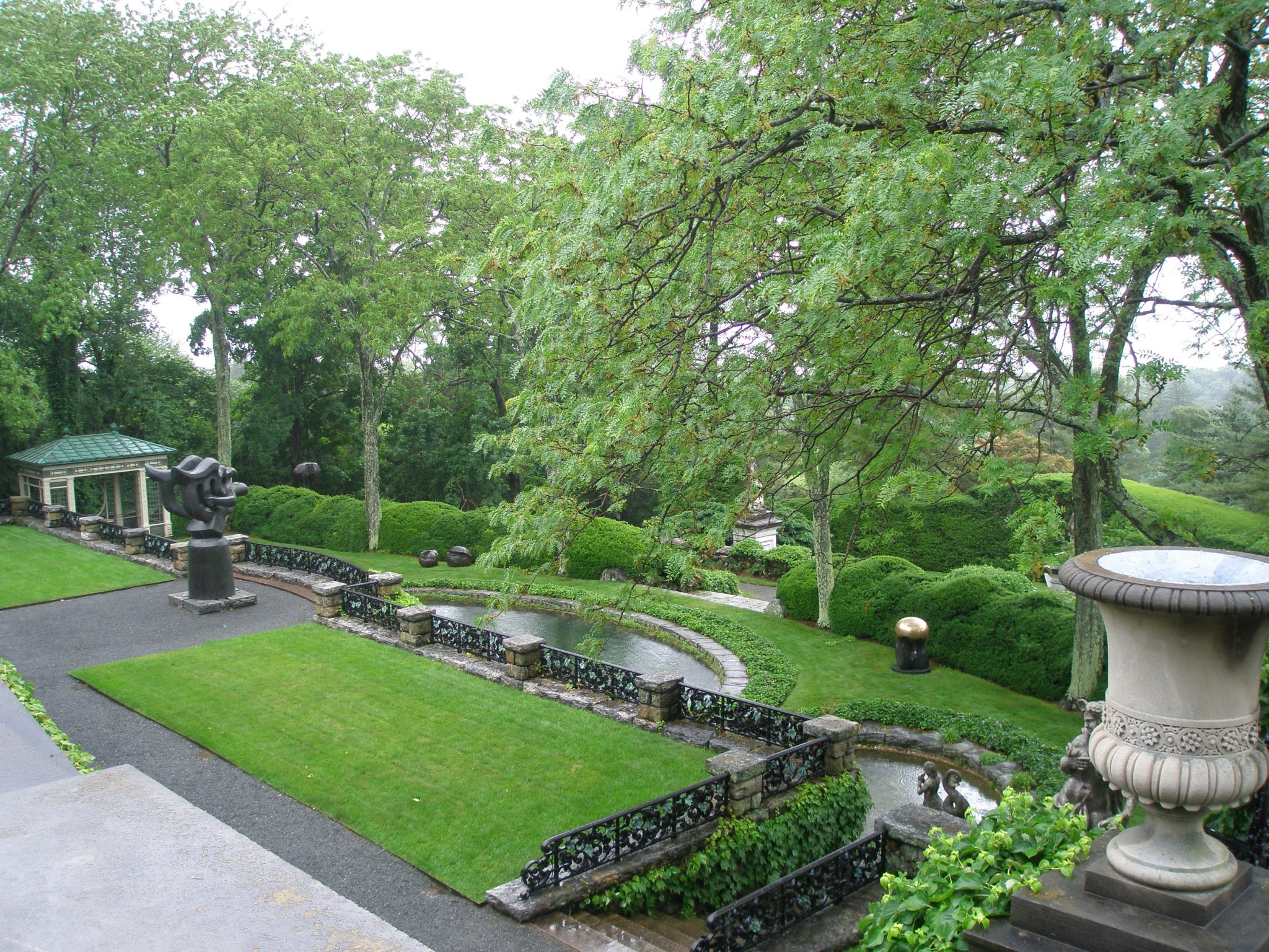 At the northwest corner of the West Porch: the view down over the Orange Tree Terrace, with the Swimming Pool Terrace below that. The winged, black sculpture is by Jacques Lipchitz: THE SONG OF THE VOWELS (1932)
