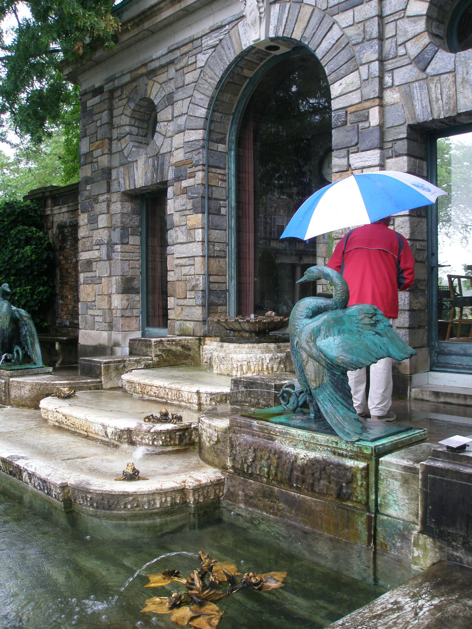 At the Tea House, a pool with more fountains by F.M.L.Tonetti. Mr. Onofrio's umbrella is keeping him only partially dry.