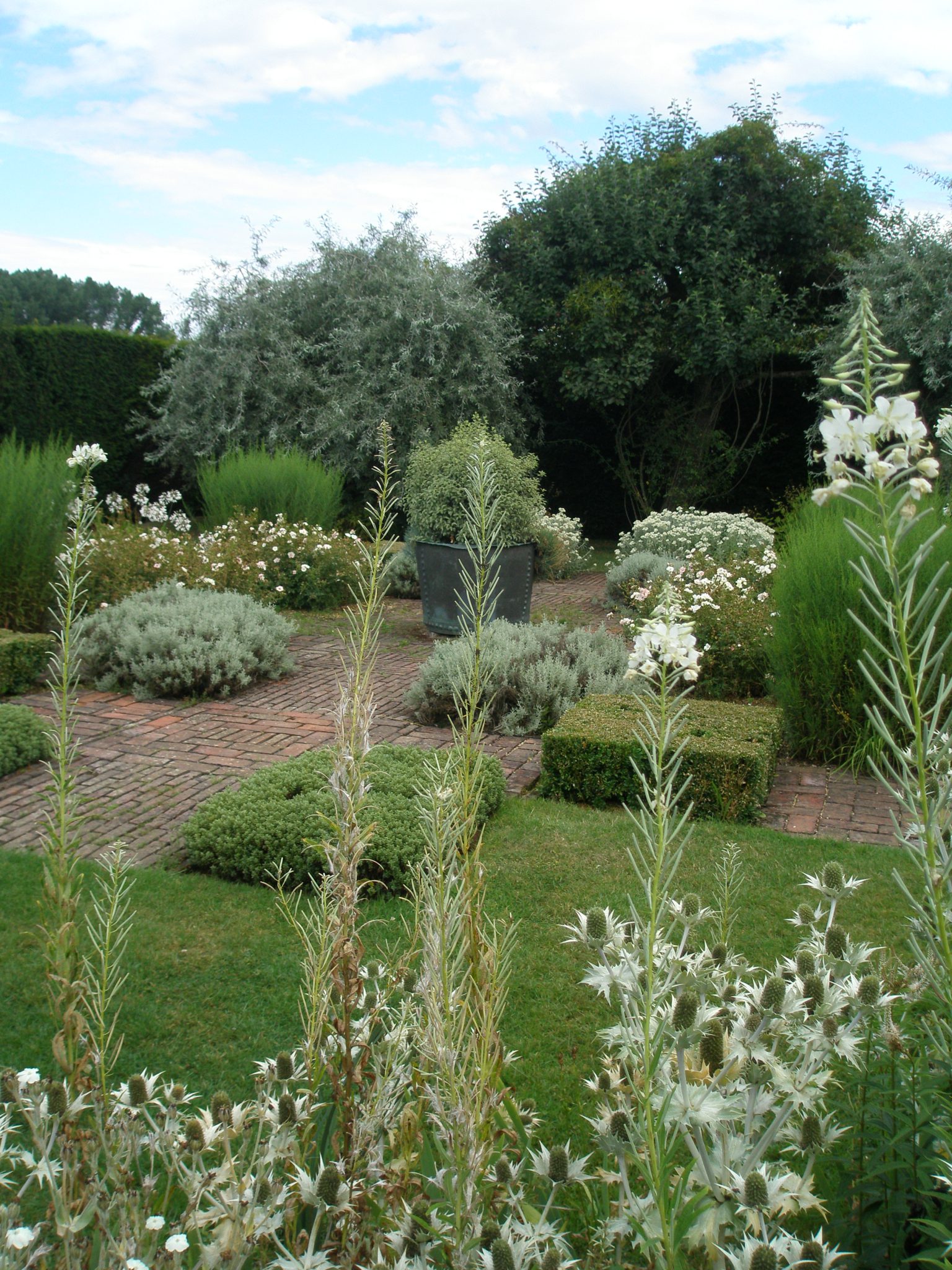 The Grey & White Garden's elegant geometry is softened by billowing flowers and foliage.