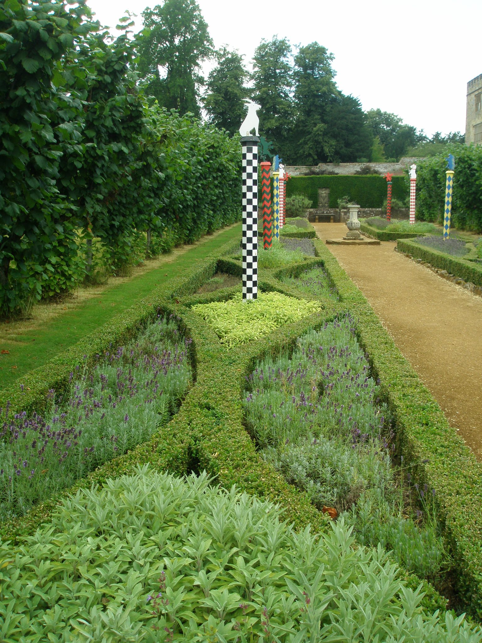 The Heraldic Garden abuts The Jubilee Walk. The Heraldic Garden's edge beds are partitioned by box hedges containing sage and lavender. The painted poles, always the focus of heraldic gardens, are topped with various beasts...all symbols of the Sidney family.