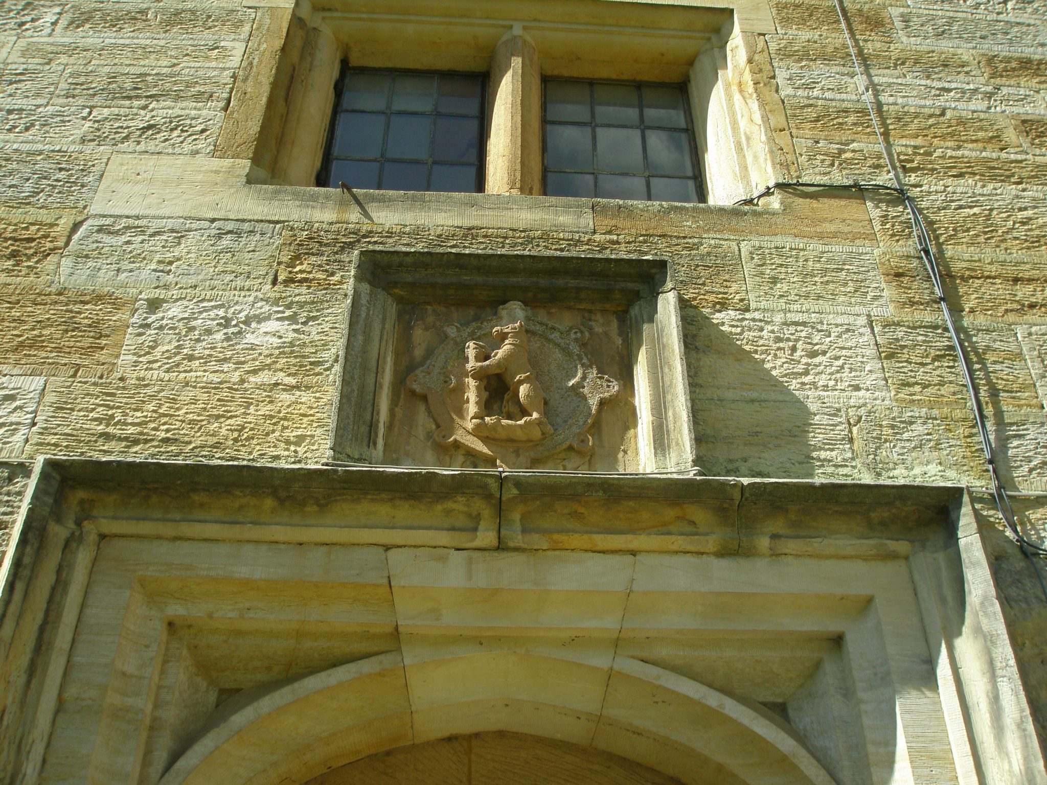 Another Dudley family Bear With Ragged Staff, this one carved atop a doorway.