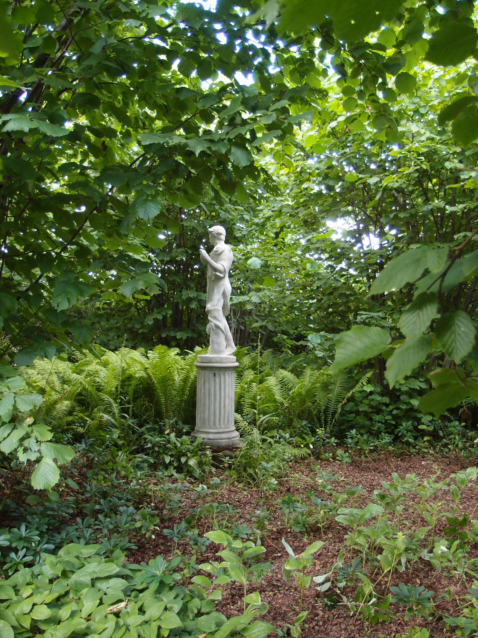 At the far end of the Spring Garden's Lime Walk, a statue marks the beginning of The Nuttery