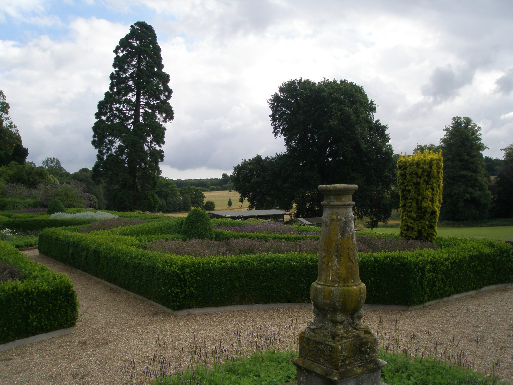A mossy, marble column is mounted at the center of the Parterre.