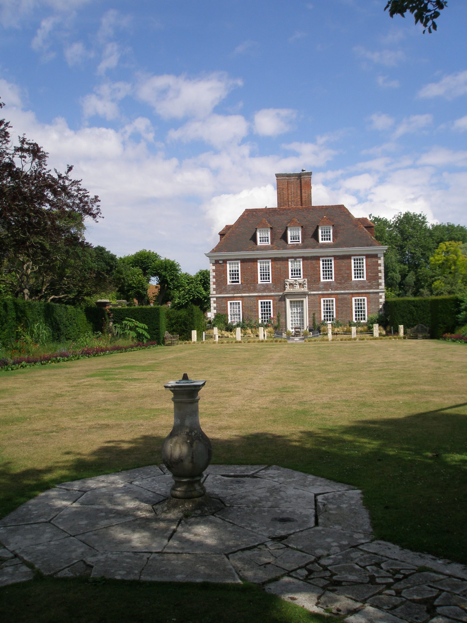 At one end of the Spring Garden, behind tall yew hedges, is the Bowling Lawn. which frames the best view of the House. This is the classic view of The Salutation.