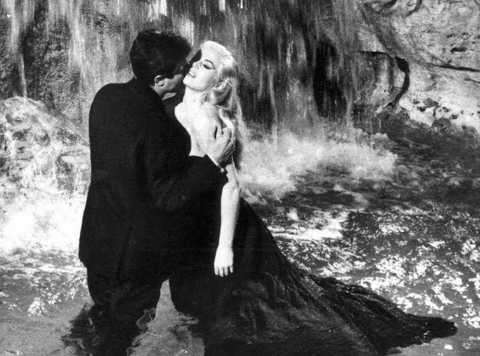 Marcello Mastroianni embraces Anita Eckberg in the Trevi Fountain scene from LA DOLCE VITA.
