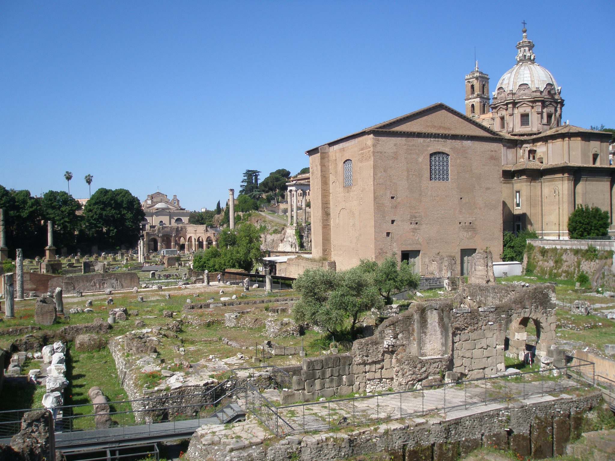 My view of the Curia (to the right) and the site of the Basilica Aemilia (to the left), as seen from the sidewalk along Via del Fori Imperiali.