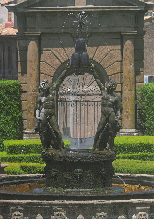 In better weather: the figures on the Island in the Fountain of the Moors garden. In the background is a gate, beyond which is the Village. Image courtesy of Il Pegaso Bookshop, in Bagnaia.