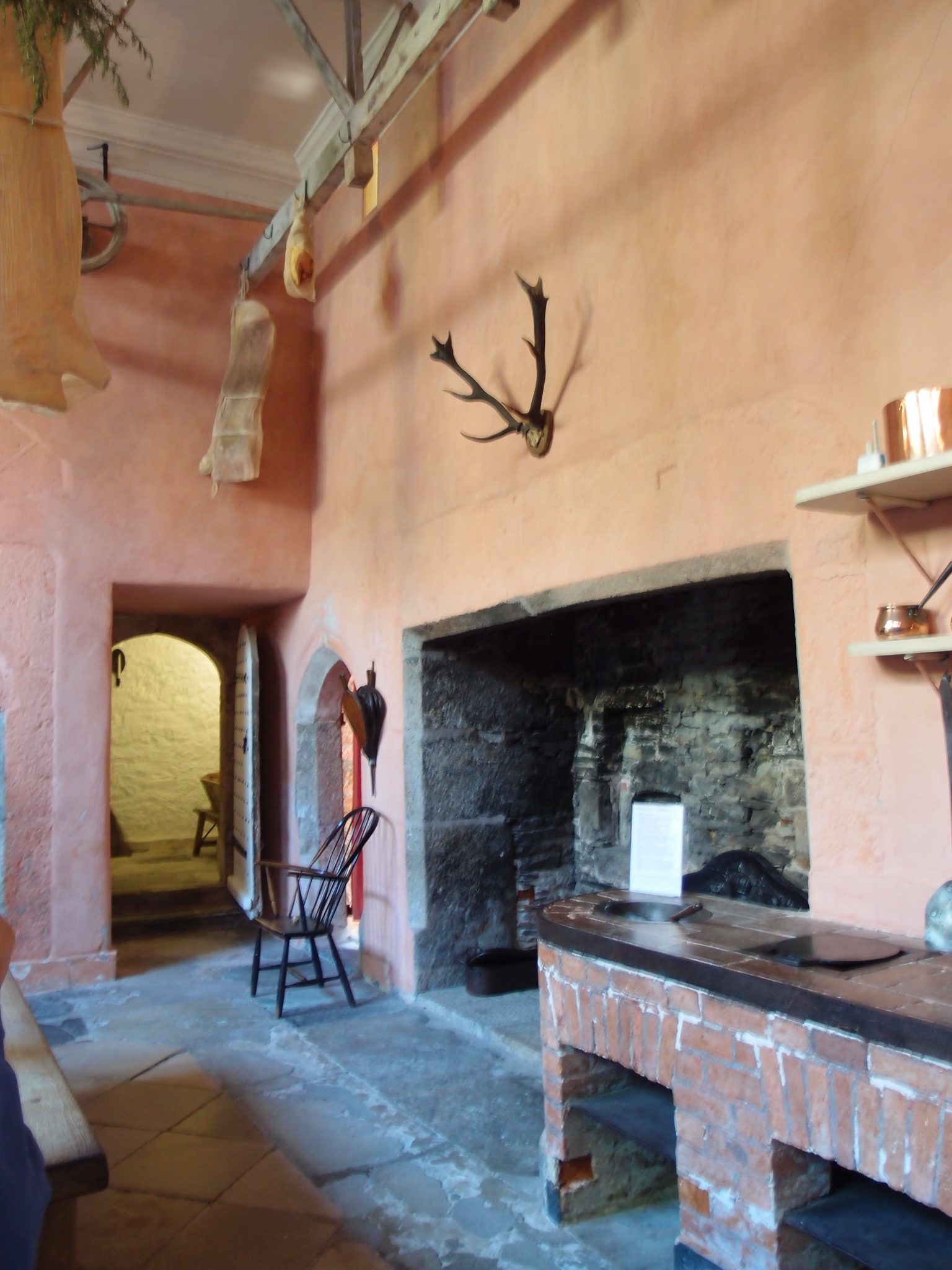  The second of the massive Hearths in the Kitchen. The antlers above the south Hearth are (fancifully) said to belong to a stag who once chased Sir Francis Drake up a tree. 