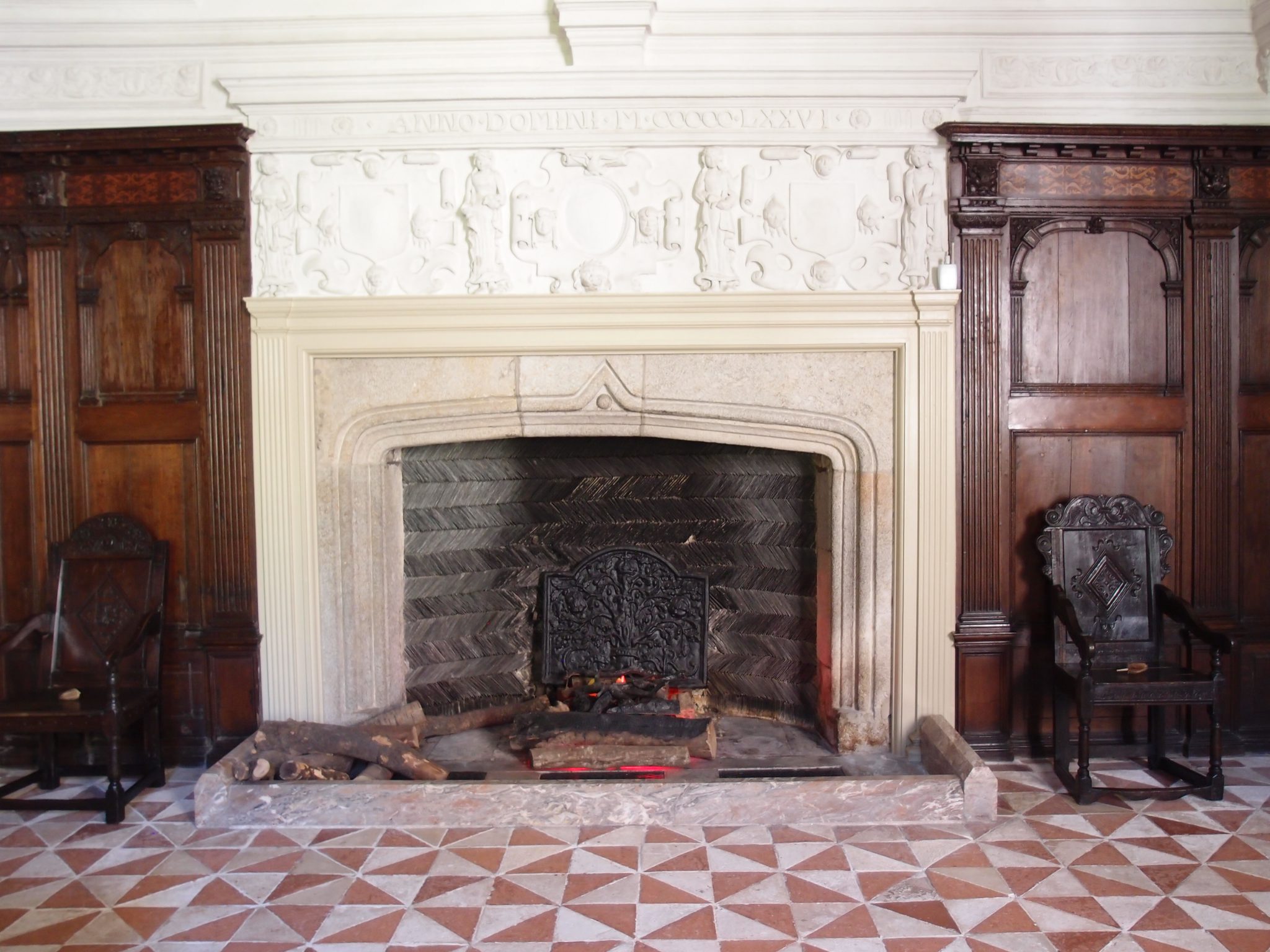 The Great Hall's granite fireplace, with herringbone pattern of slate at the back, is typical of the 16th century.