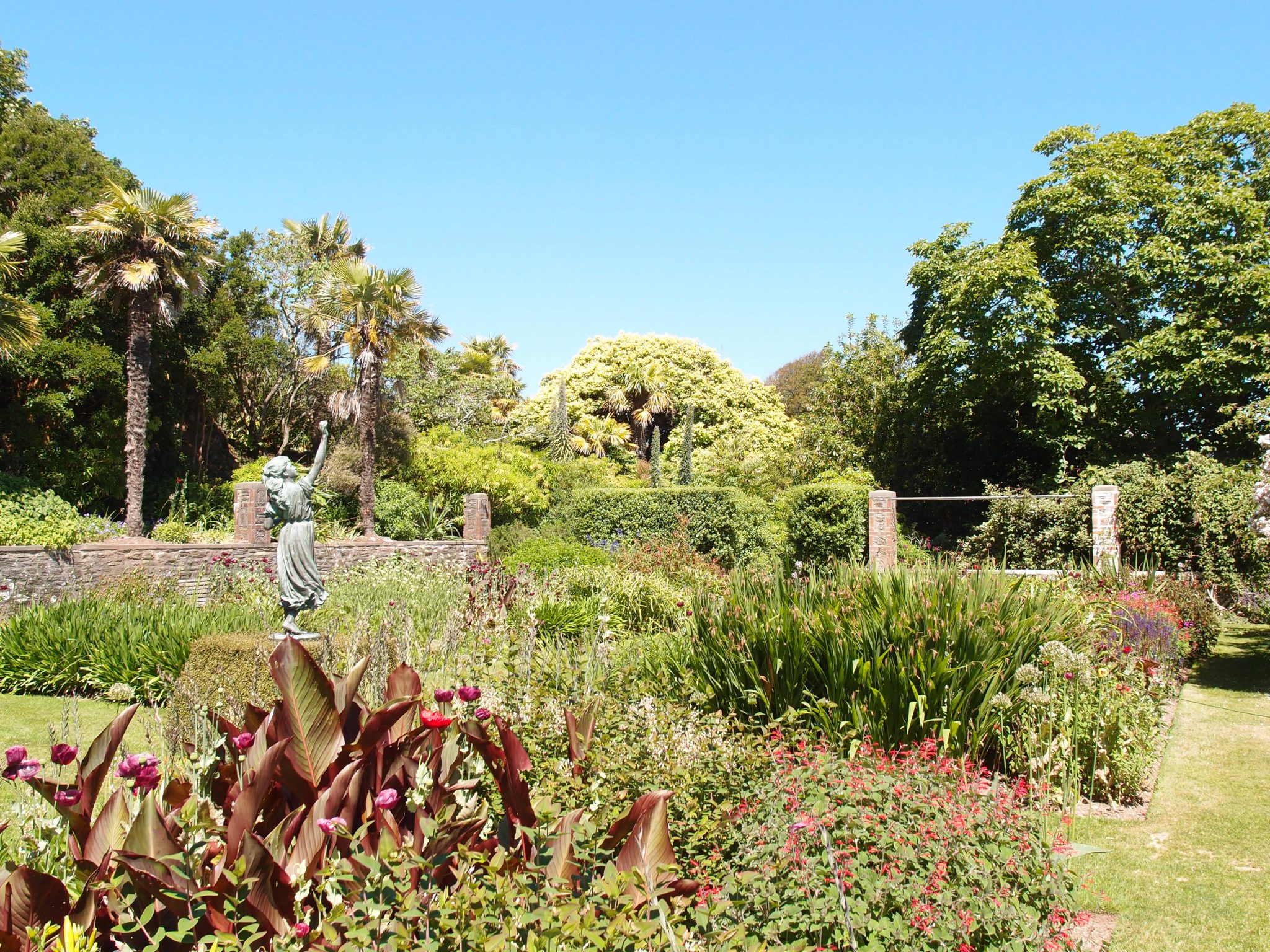  We enter the Statue Garden, which contains lush plantings of tender perennials: poppies, salvias, agapanthus, cannas, kniphofias, inulas and heleniums…all chosen as sources of food for the bees and butterflies who flock there, from early June through the end of Autumn. 