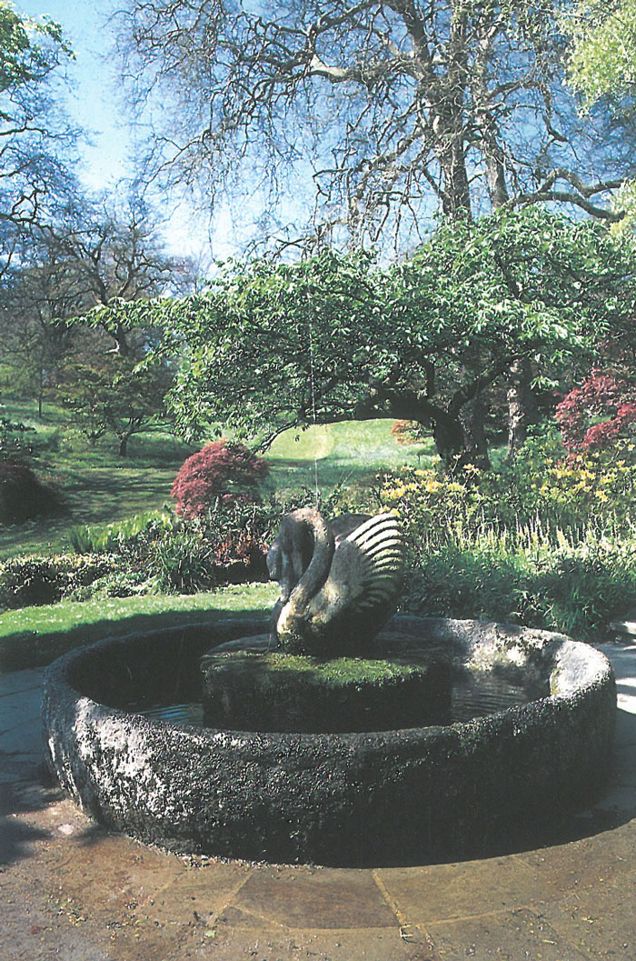 Swan Fountain, in Springtime, when Beatrix Farrand's Woodland shrubs begin to flower. Image courtesy of Dartington Hall.