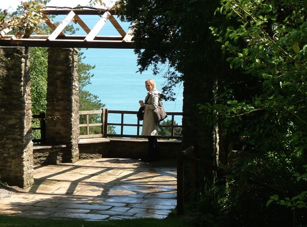 Nan...doing a bit of sun-basking, in the Gazebo. The hexagonal Gazebo, with stone pillars and a wooden trellis to support wisteria, offers a spectacular ocean view. When it was first built, the Gazebo also had a clear view inland, back to the House. Photo by Anne Guy.