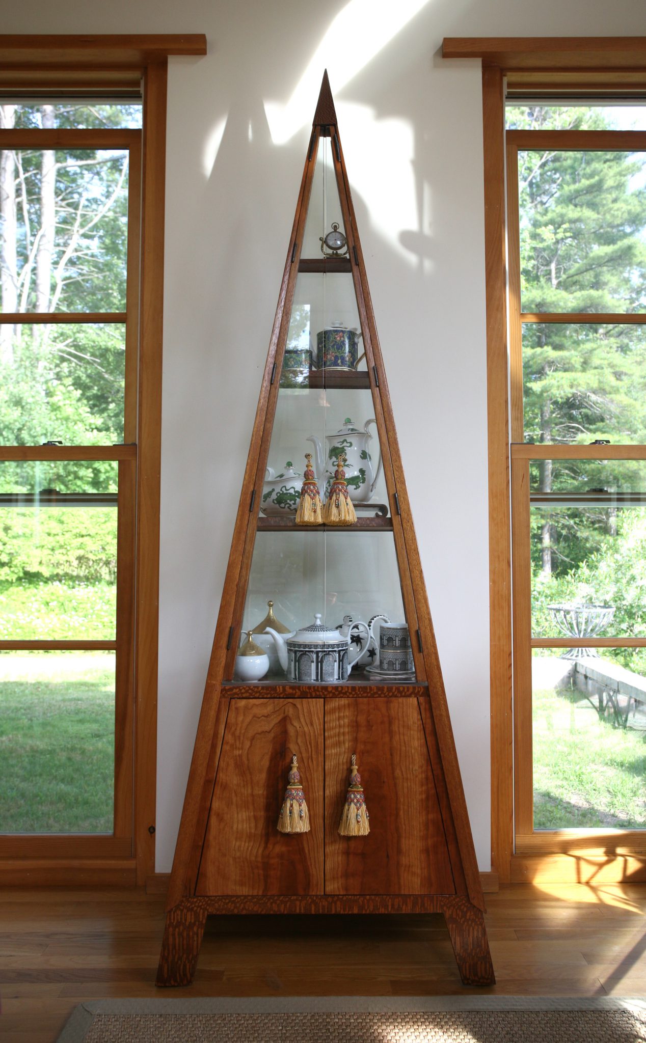 My Pyramidal Vitrine was built by Neil Ritter. I chose silk curtain tassels to use for the door-pulls.