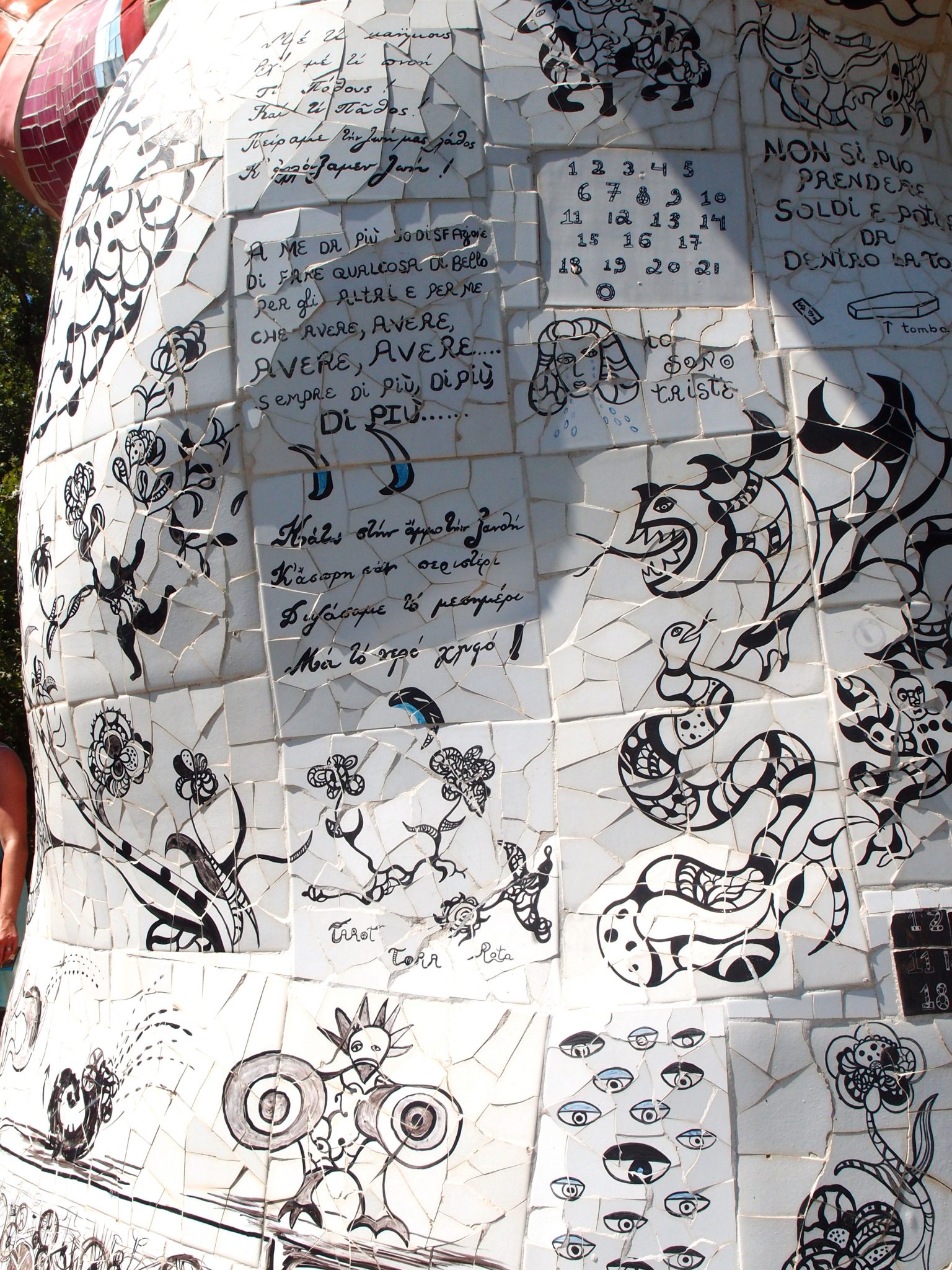 Detail of exterior of the Tree of Life. The tiles on the outside of this structure are densely covered with Niki’s scrawls. Translated, they’re a timeline of a love affair, which ends in heartbreak. With drawings and these words, Niki begins: “I would like to give you everything, my mouth, my money, my imagination, my breast, my time, my terrific cooking, my everything.” Many tiles later, she writes “What shall I do now that you’ve left me? Will I cry a million tears? Will I die? Will I take to drink? Take a trip? Will I consult the stars and a crystal ball on how to win you back? Will we stay friends?” 
