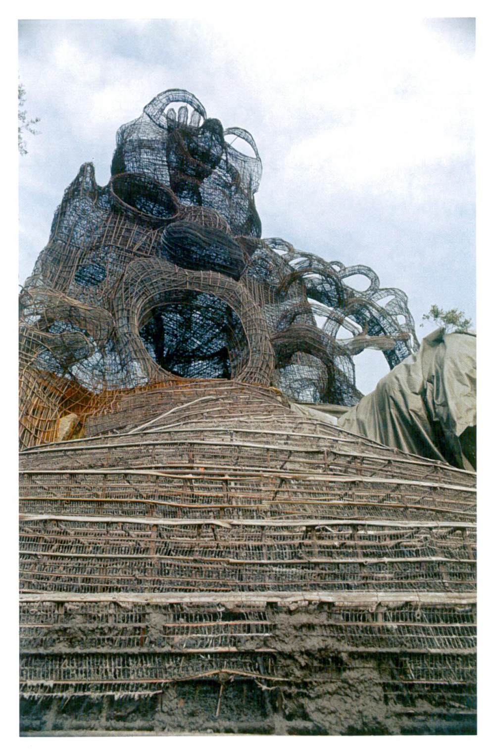 The High Priestess, with The Magician atop her, under construction, in 1982. All rebar has now been placed, and cement will soon cover the entire structure. Image courtesy of Il Fondazione Giardino Dei Tarocchi.