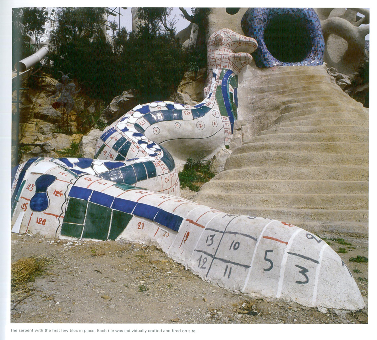 Detail of Serpent by the waterfall of the High Priestess, under construction. The first tiles have been affixed. Each tile was individually crafted and fired on site. Image courtesy of Il Fondazione Giardino Dei Tarocchi. 